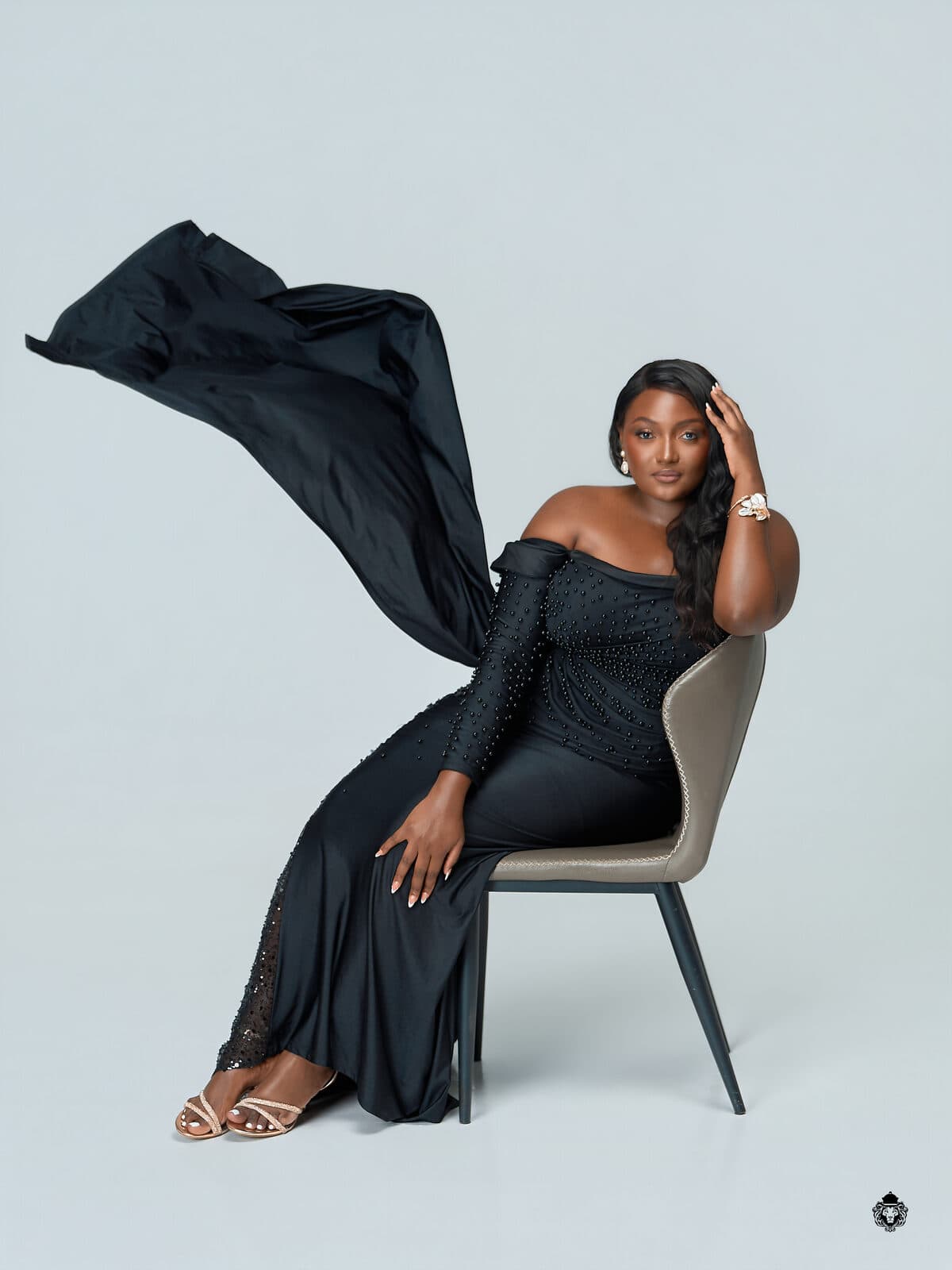 Miriro Munodawafa seated in a black evening gown