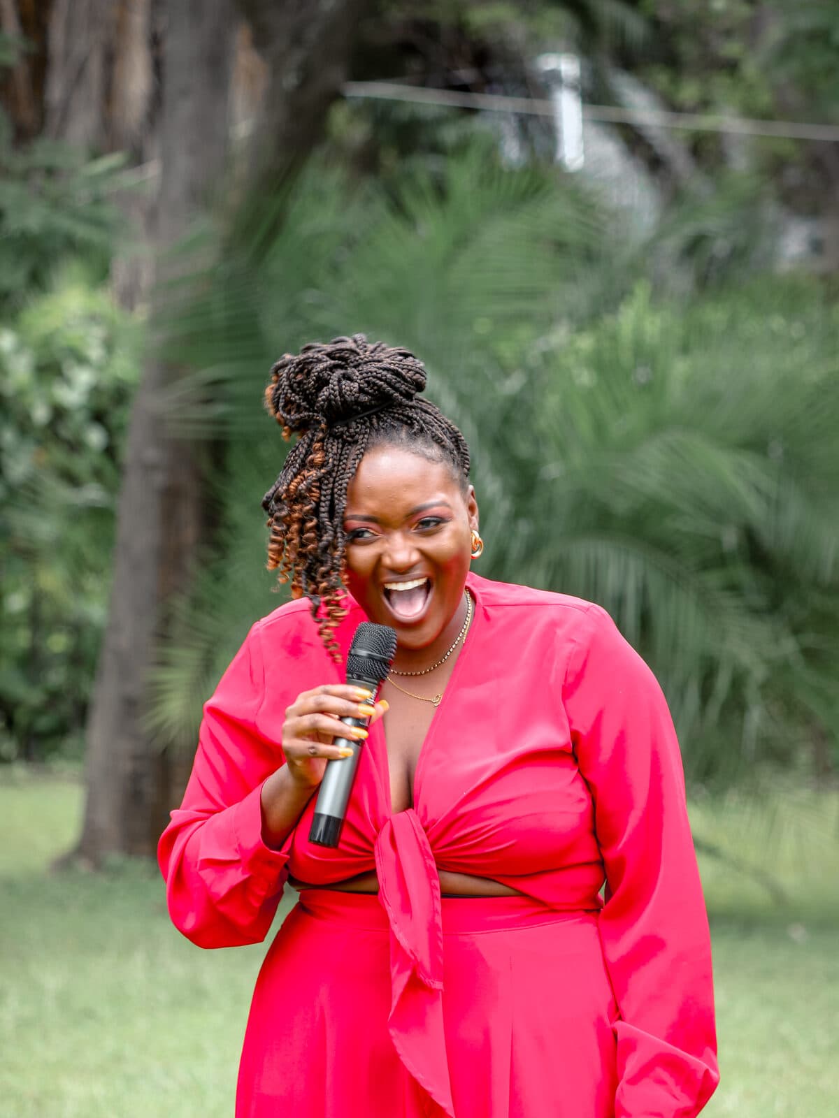 Miriro Munodawafa holding a microphone mid-conversation