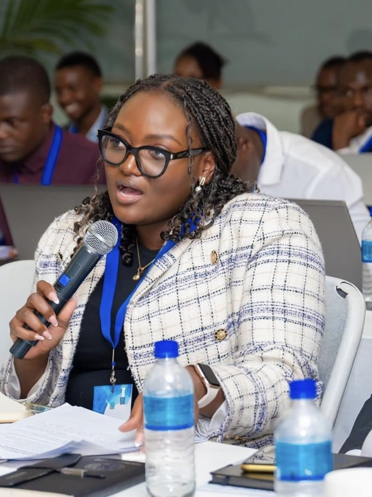 Miriro Munodawafa speaking into a microphone at a youth skills workshop